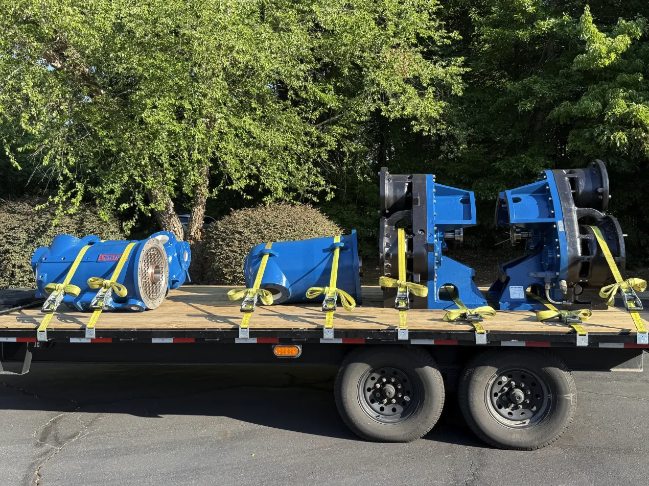 Rebuilt compressors strapped and secured on a trailer for delivery and installation