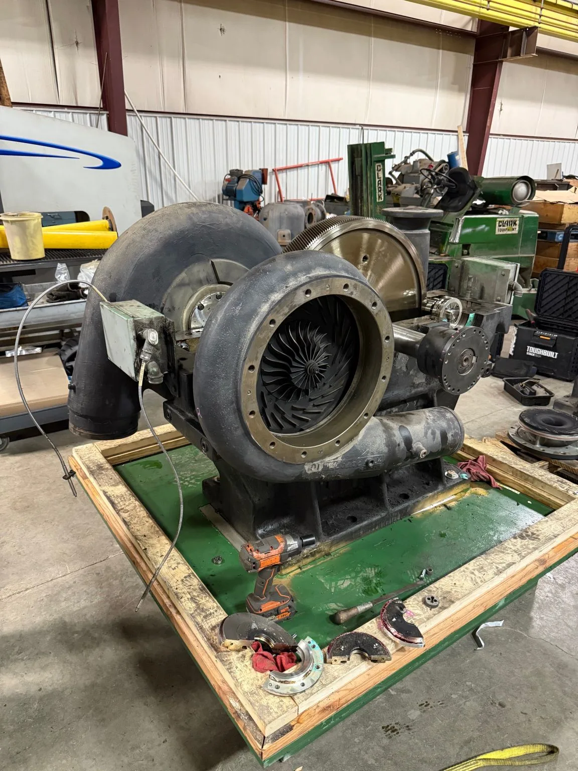 Rebuilt Joy MSG Series TA-50 centrifugal compressor on its skid in The Fischer Group shop, impeller visible through the open inlet
