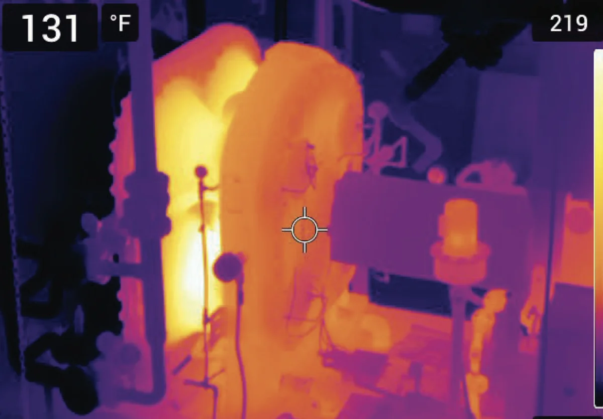 Thermal image of a centrifugal compressor package, with the casing glowing orange and yellow against cooler surroundings